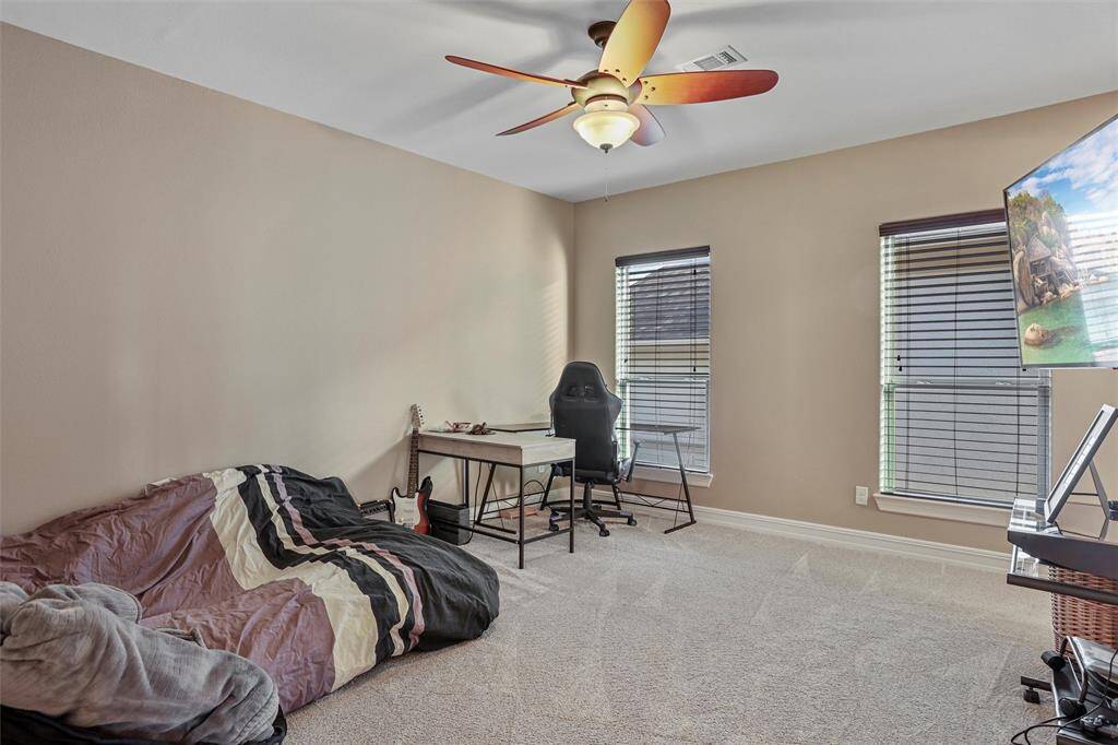Spacious second bedroom with natural light, perfect for relaxation or a home office.