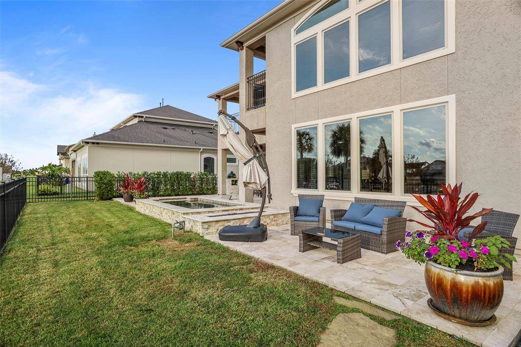 Enjoy the inviting backyard with a stylish sitting area perfect for relaxation and entertaining.
