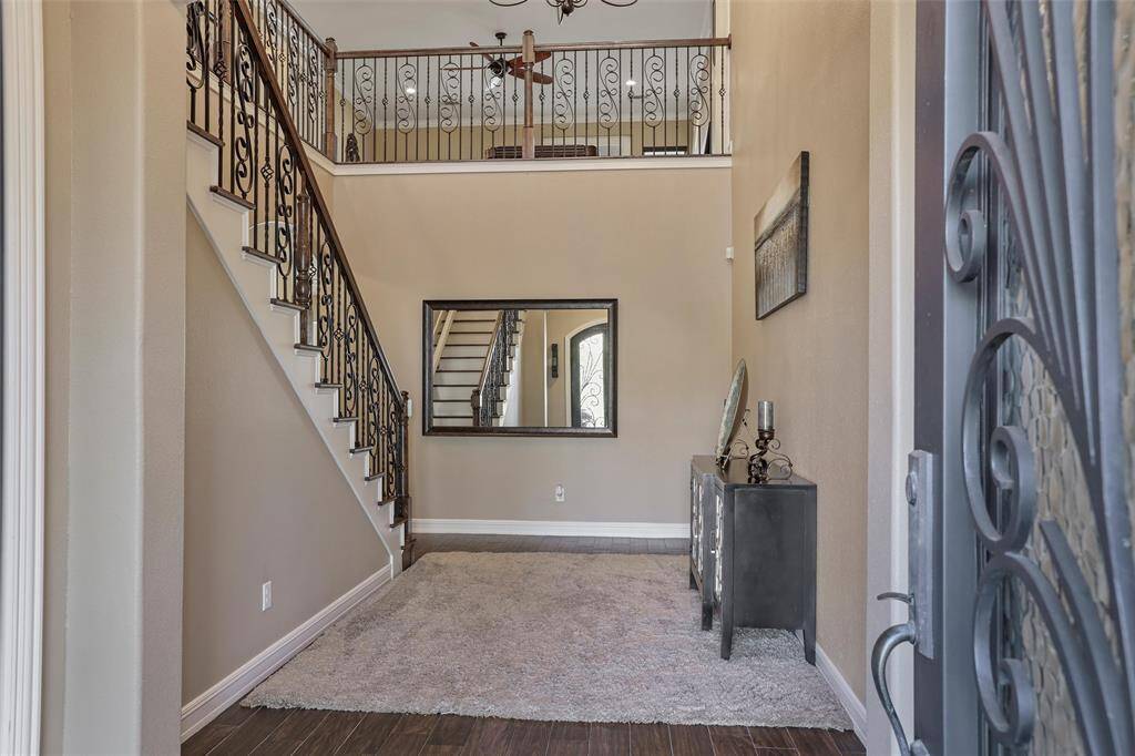 Welcome home to an inviting foyer featuring elegant wrought iron doors.