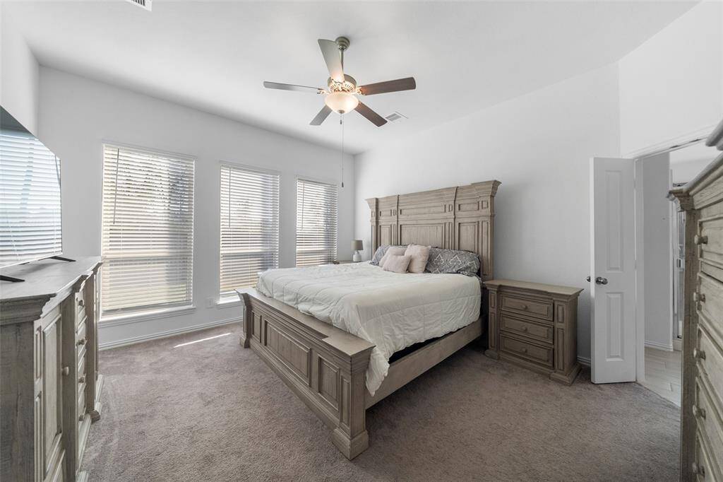 The large primary bedroom offers ample space to accommodate oversized furniture, creating a luxurious and comfortable retreat.