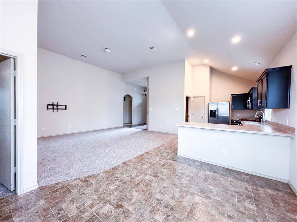 View from dining space to kitchen and living room