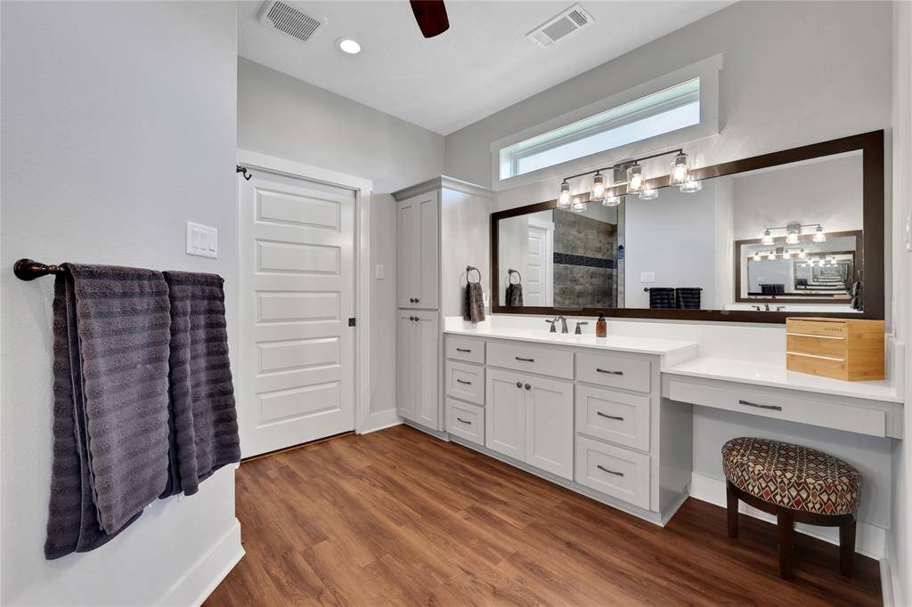 The primary ensuite bathroom has dual sinks, vanity area and plenty of storage