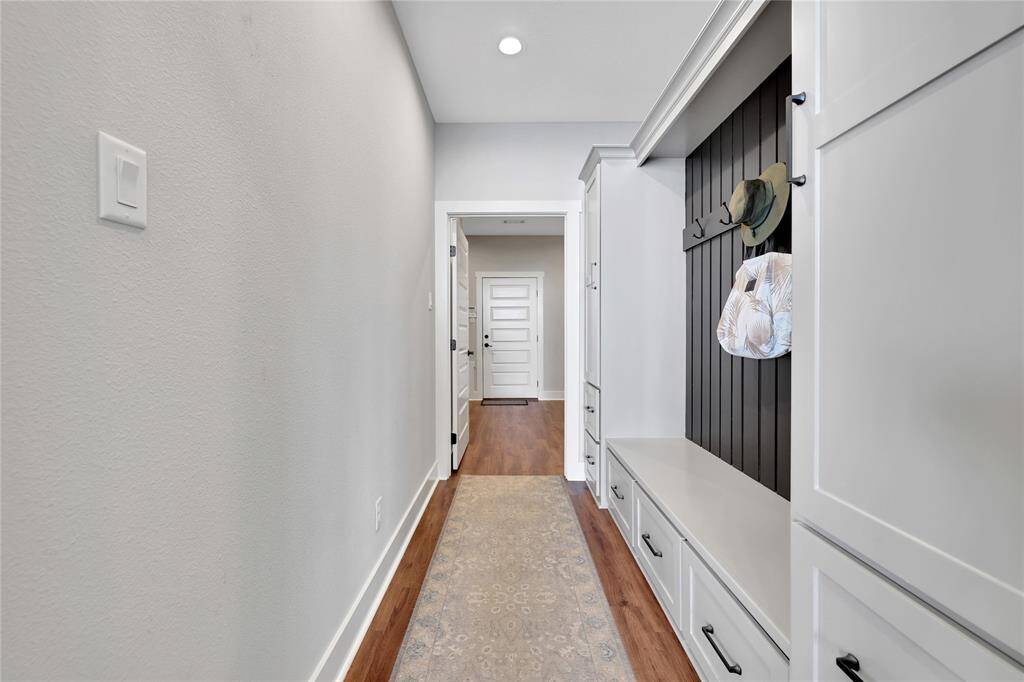 Between the living area and the laundry room is a mudroom with coat hooks and storage