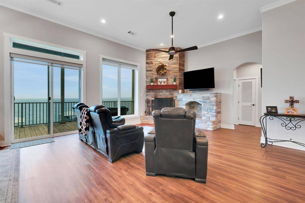 The living area features a wood burning fireplace with gas start, stone surround and custom mantel