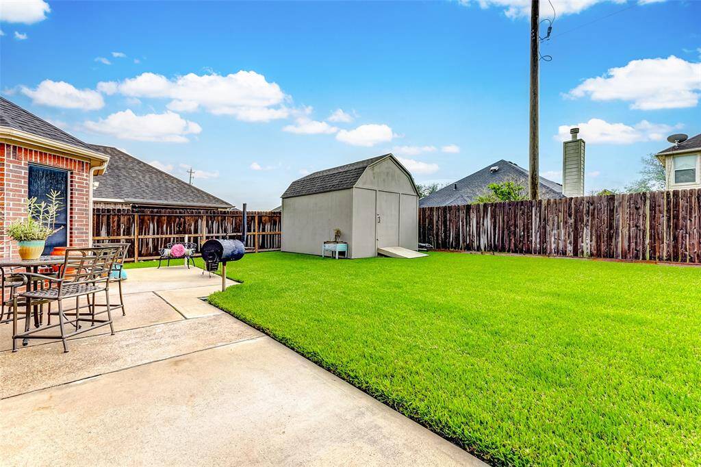 LARGE BACKYARD PATIO WITH STORAGE SHED
