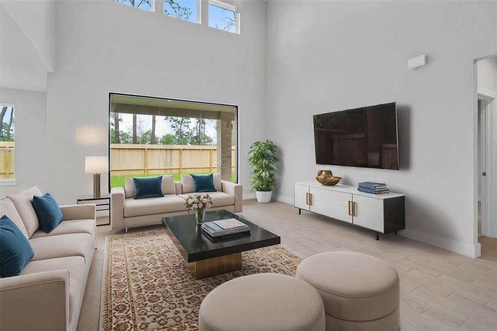 Gather the family and guests together in your lovely family room! Featuring high ceilings, recessed lighting, custom paint, gorgeous floors, and a large picture window that provides plenty of natural lighting throughout the day.