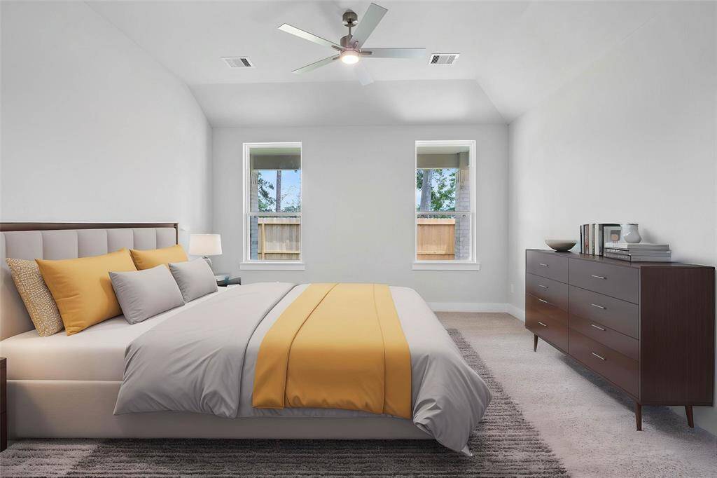 Come and unwind after a long day in this magnificent primary suite! This spacious room features plush carpet, warm paint, high ceilings, ceiling fan and large windows!