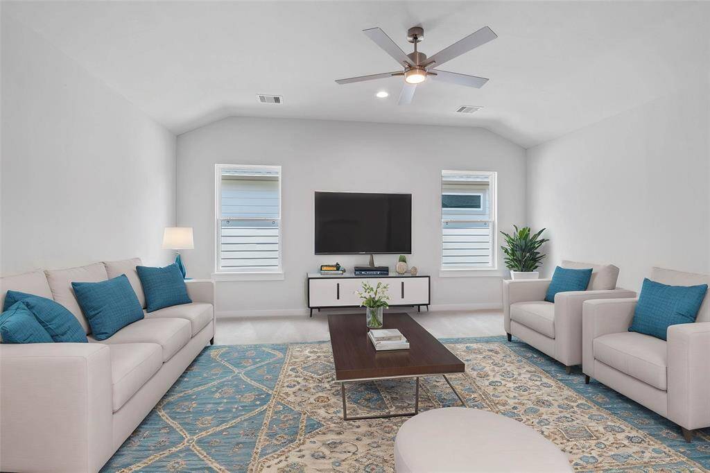 Come upstairs and enjoy a day of leisure in this fabulous game room This is the perfect hangout spot or adult game room, this space features plush carpet, high ceiling, recessed lighting, ceiling fan, custom paint and large window!