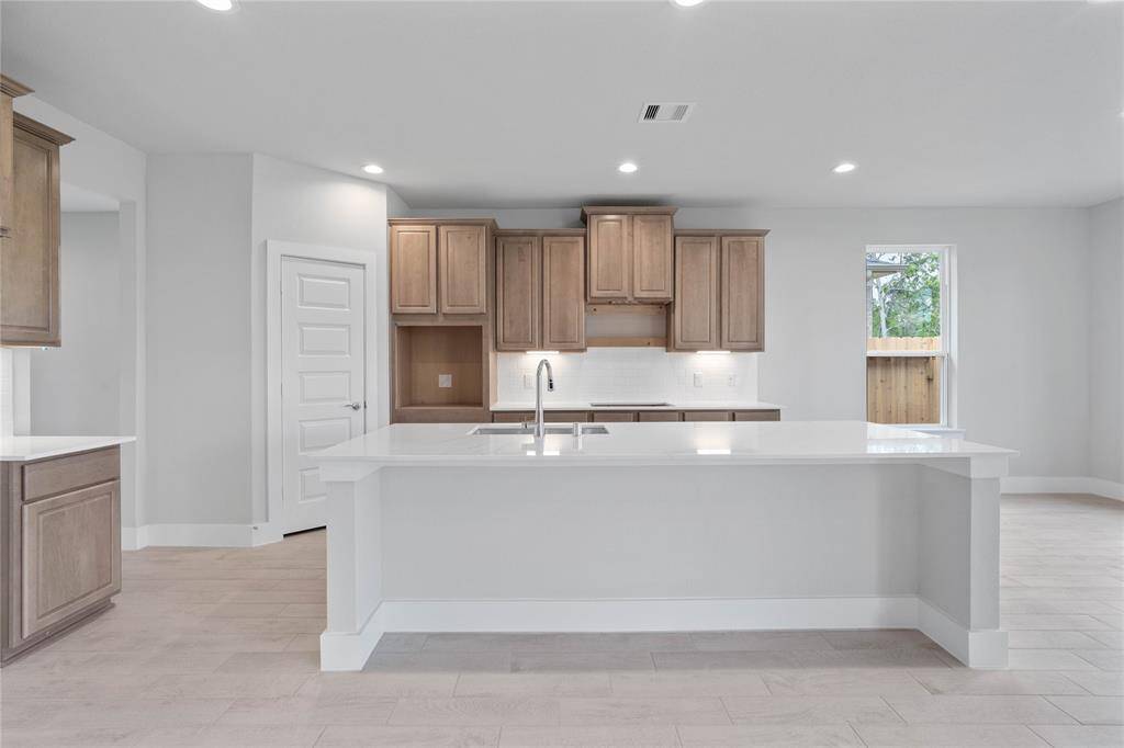 Additional view of the spacious kitchen the large quartz kitchen island!