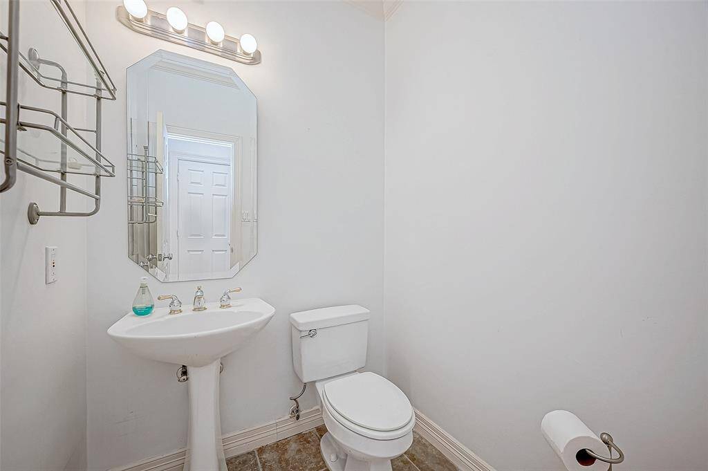 Half bath located off the family room by garage entry.
