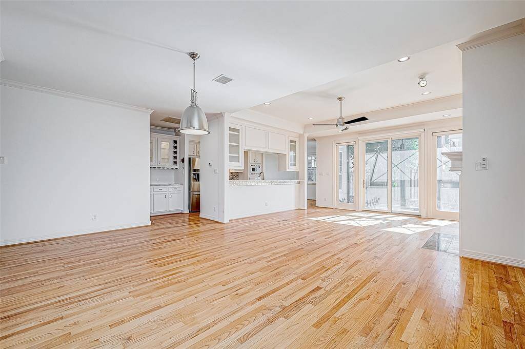 Warm and durable wood flooring flows throughout the home, adding timeless style to every room.