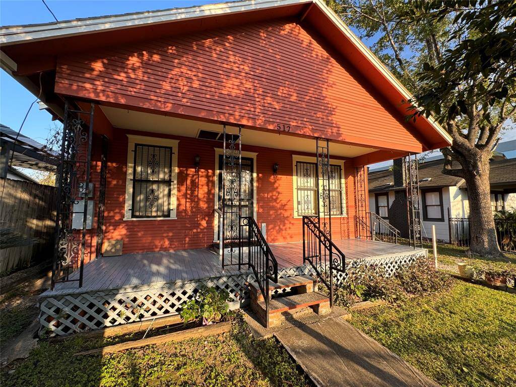 A cozy and inviting porch waiting for comfortable seating, perfect for relaxing or spending time with loved ones!