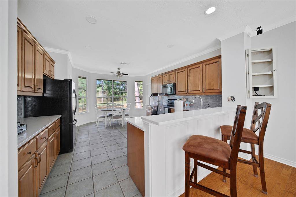 Breakfast bar leading into the generous size kitchen with many upgrades!