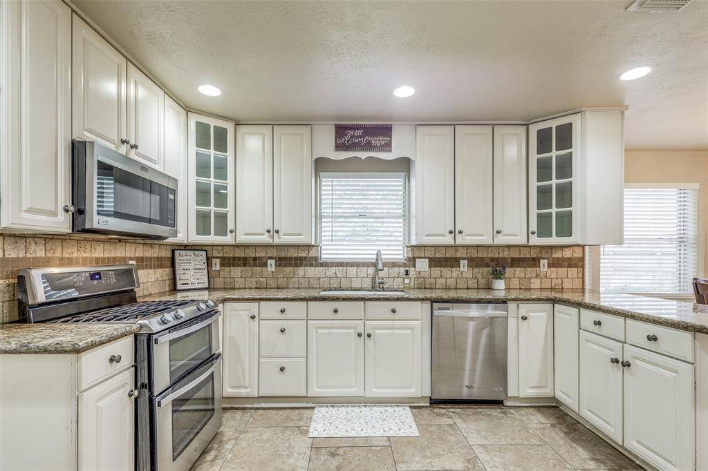 The window above the kitchen sink offers a view of the backyard.