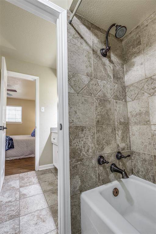 Primary bathroom shower and toilet area.