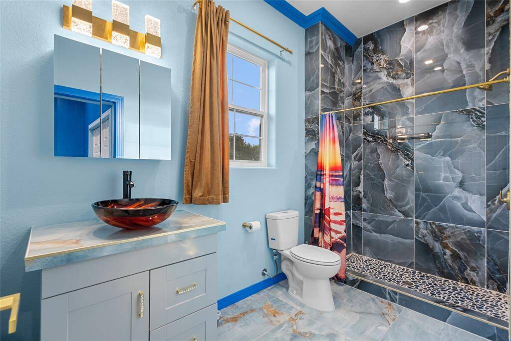 Full bath 2nd floor, with creative fixtures and sink bowls, porcelain floors and showers and lots of storage