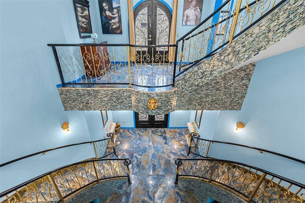 Looking down at entry from 2nd floor and up staircase to 3rd floor