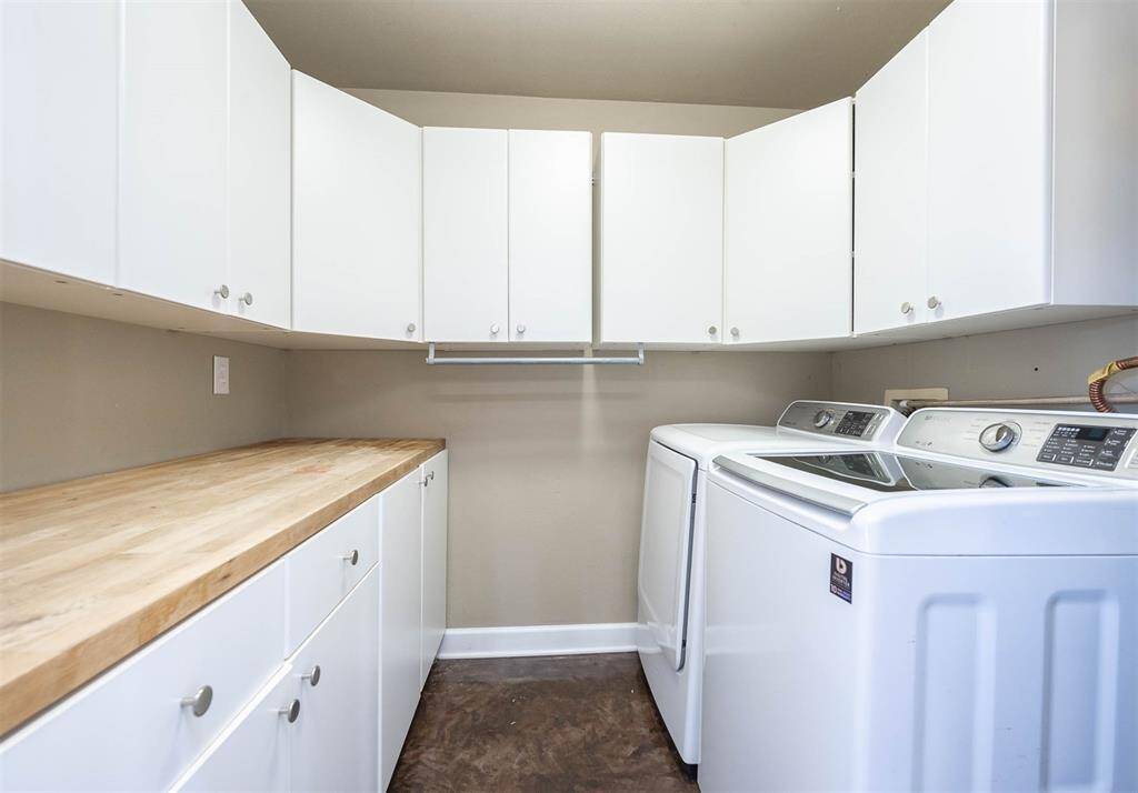 The Laundry Room With Folding Area And Plenty of Storage.
