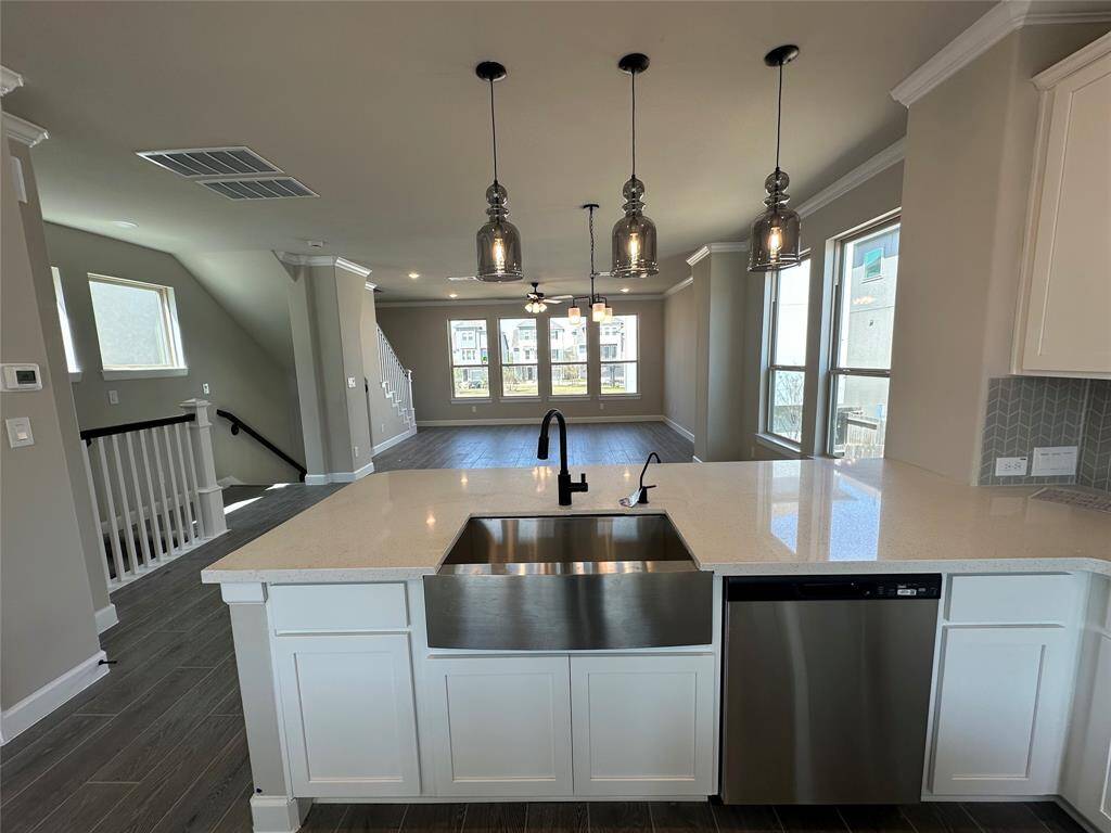 Kitchen overlooks dining area and great room