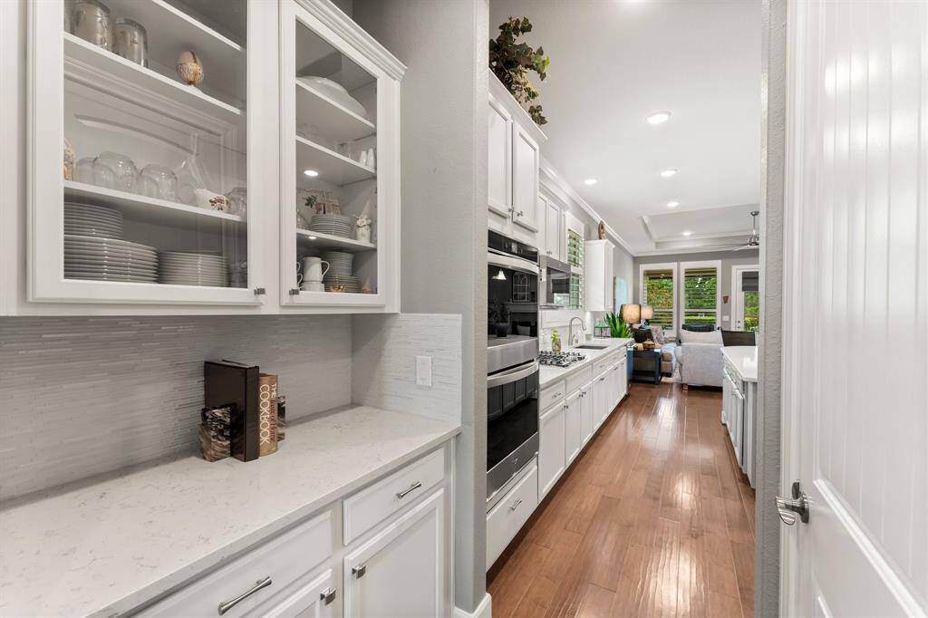 Butler pantry with upgraded overhead glass door cabinets.