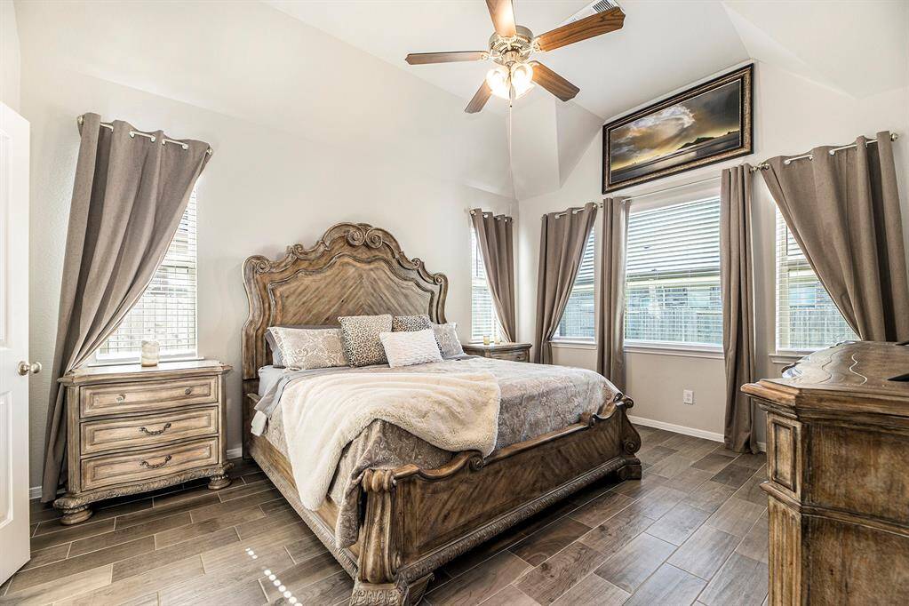 The primary downstairs is a perfect retreat with high ceilings and beautiful architecture.
