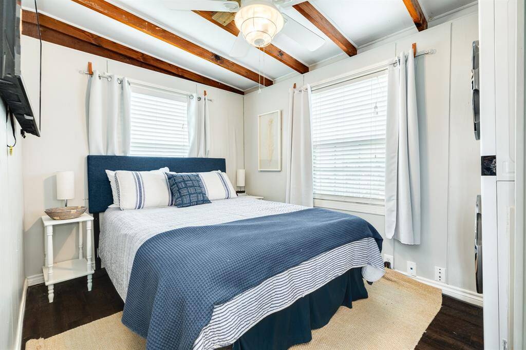 The master bedroom has lots of bright light, big screen tv and lots of closet space.