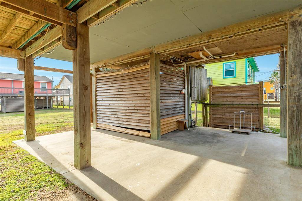 There are 2 outside storage areas.  One has a barn door that is going to be repaired asap.  A foot washer and full shower outside keep the sand at bay.