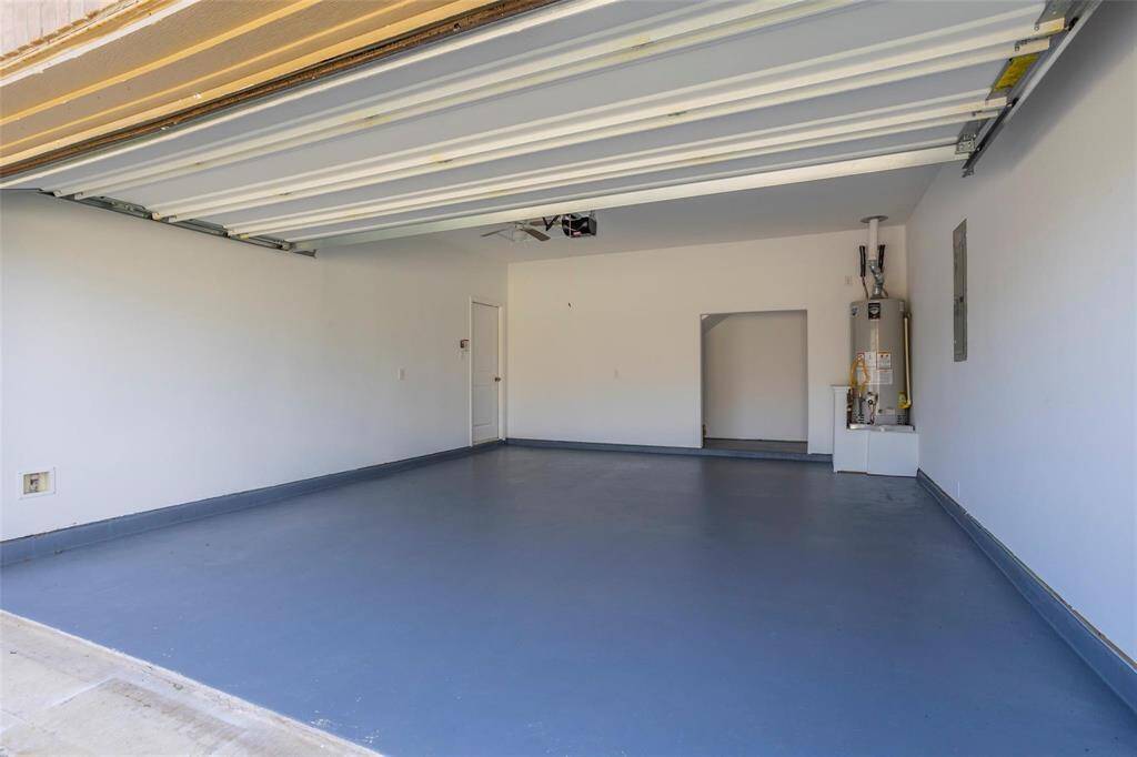 2 car garage with extra storage painted flooring