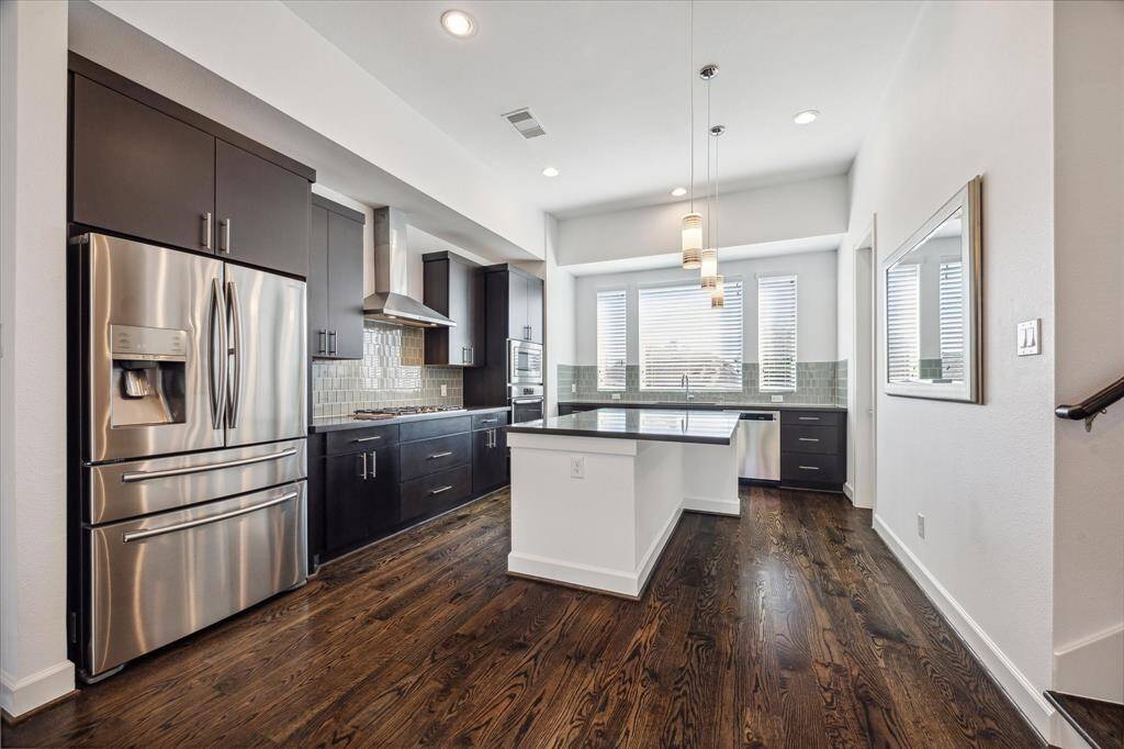 Large island kitchen with breakfast bar. Separate pantry area for extra storage.