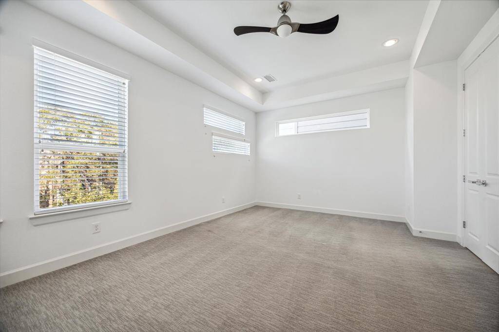 Located on the 3rd floor, the primary bedroom with coffered ceiling, great lighting from the window that looks out to the front of the home.