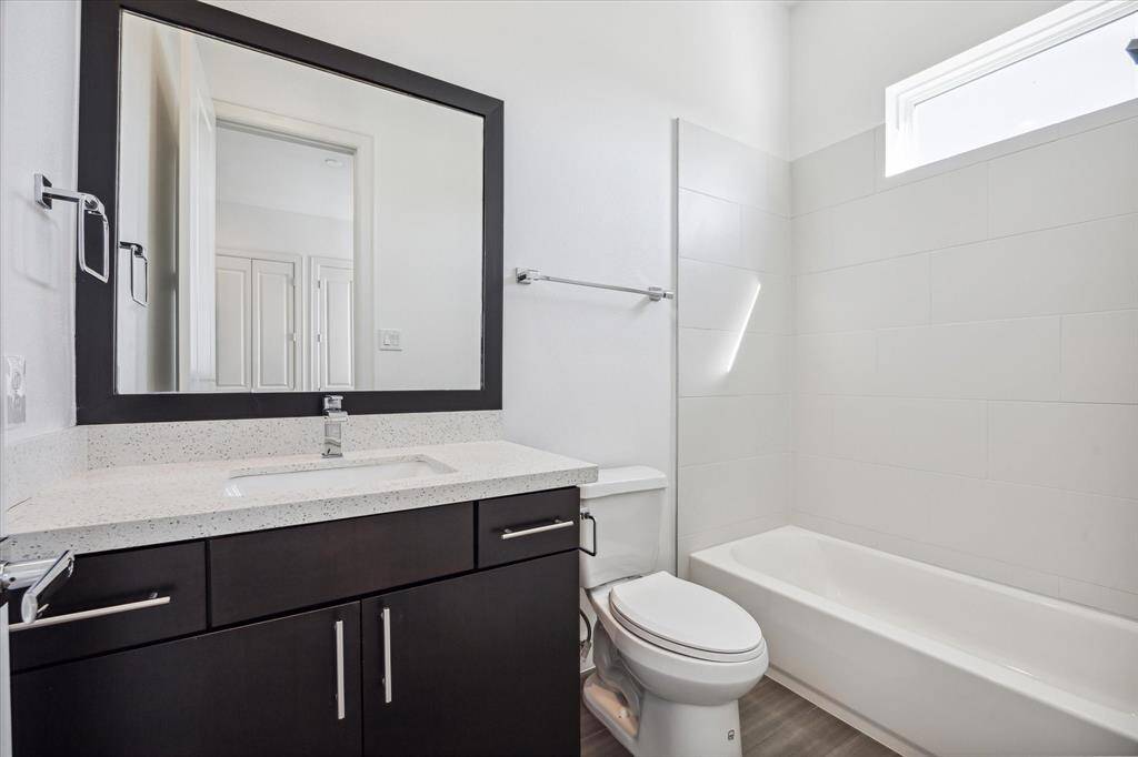 En-suite bathroom, located in the secondary bedroom includes, single sink vanity, and tub/shower combo.