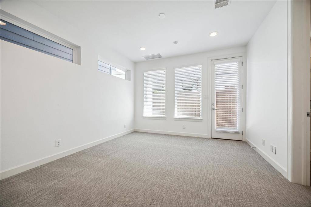 First floor bedroom has a great feel with lots of natural lighting. There is access to the back patio from this room.