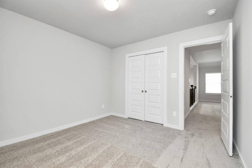 Generously sized secondary bedrooms, complete with spacious closets and soft, inviting carpeting. Sample photo of completed home with similar floor plan. Actual colors and selections may vary.