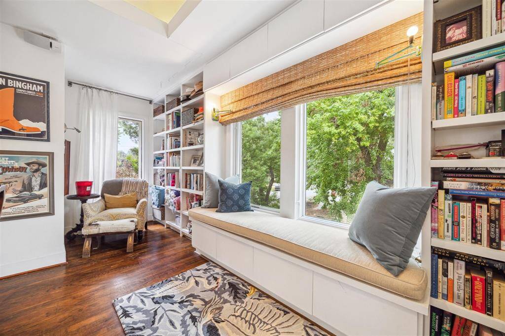 Window seat and reading nook nestled between custom built-ins.