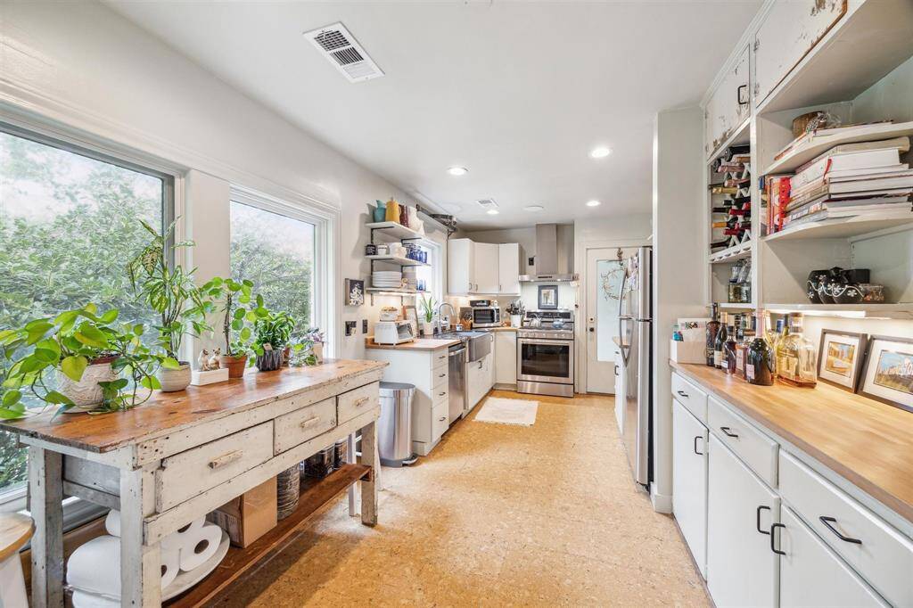 Fully updated kitchen and breakfast area with stainless appliances and massive custom farm sink.