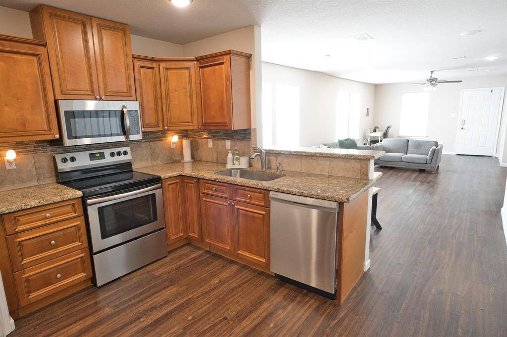Beautiful stainless steel appliances and granite countertops.