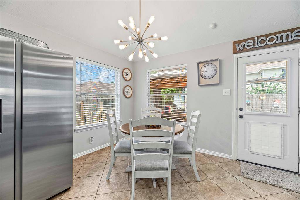 This light and bright breakfast area features a stunning chandelier and plenty of room for your breakfast table.  Enjoy morning coffee and cornflakes while enjoying the views from the surrounding windows. This cheerful space is the perfect spot to start your day.