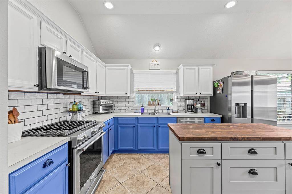 Ditch the takeout and cook from home more often! This fabulous island kitchen offers sleek stainless steel appliances including a gas range, built-in microwave, and an automatic dishwasher.