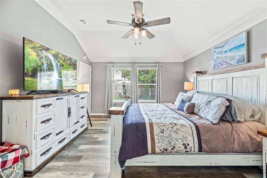 You'll have sweet dreams in this luxurious owner's retreat. This serene retreat offers durable and beautiful updated flooring, neutral paint, a raised ceiling with thick crown molding and a lit fan, a large walk-in closet and a stunning ensuite bathroom.