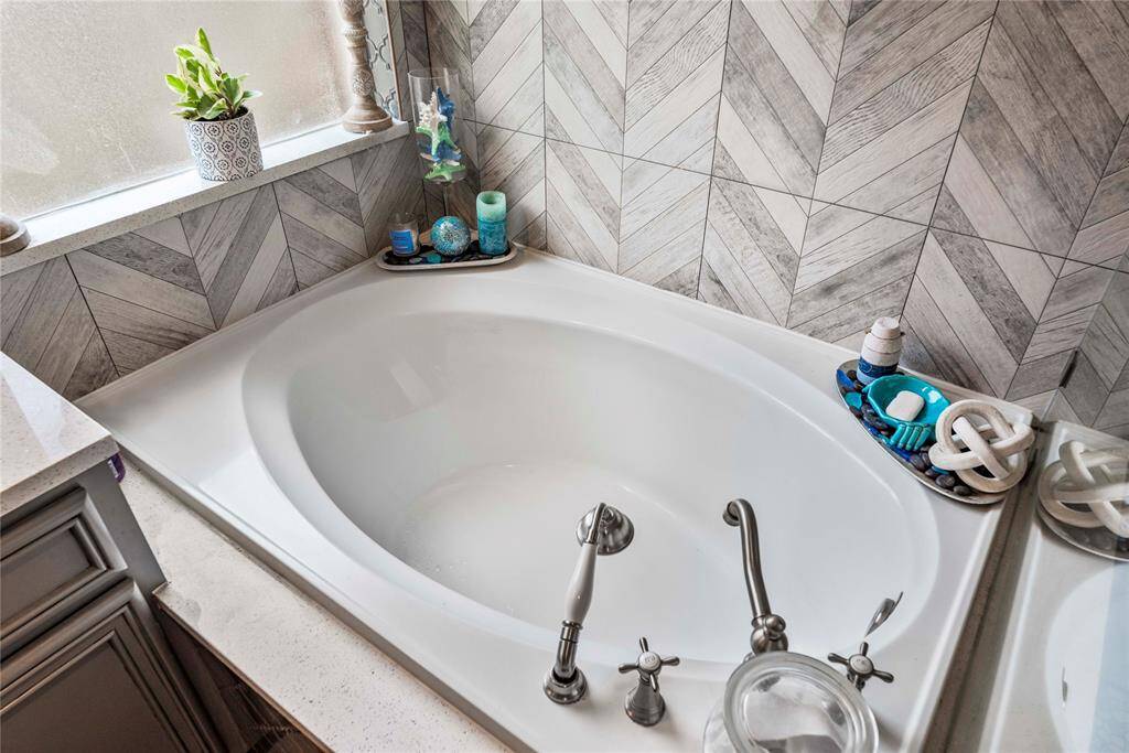 Let the stress melt away as you relax in this serene and tranquil space, designed for ultimate comfort and relaxation. Surrounded by beautiful tile work and thoughtfully designed details, this oversized tub is the ideal spot to soak your worries away.