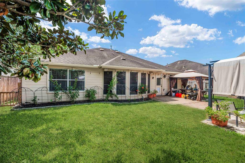 The fenced backyard is ready for barefoot fun with an extended patio, fenced side yards, a storage shed, and ample space for outdoor play.