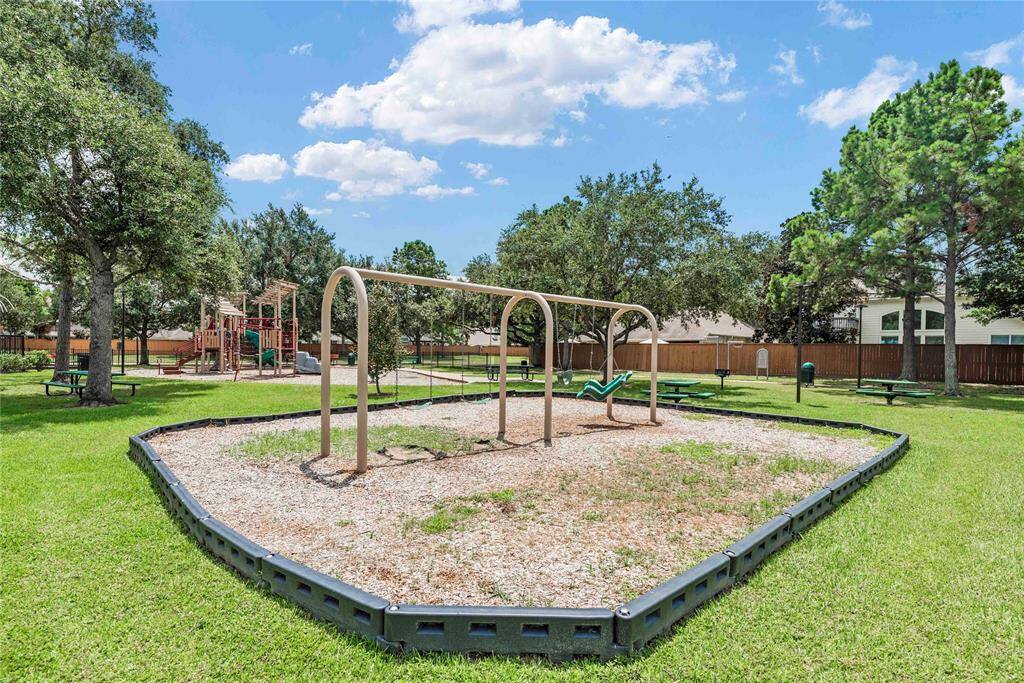 Neighborhood amenities close to home include a well-equipped playground and a set of swings, perfect for keeping children entertained and active.