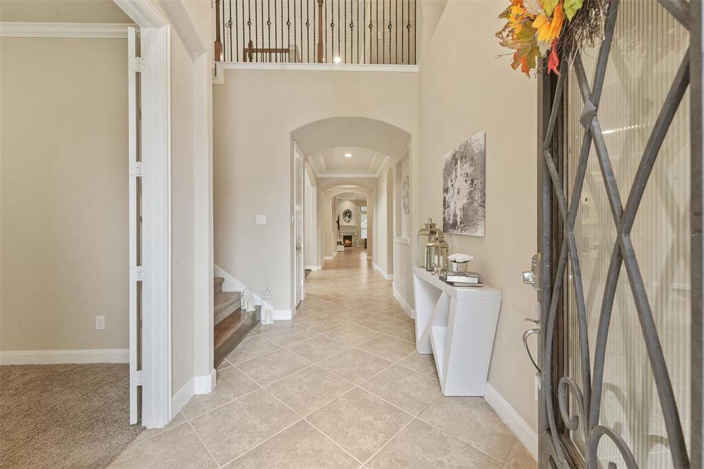 Elegant entryway with a grand staircase and stylish decor.