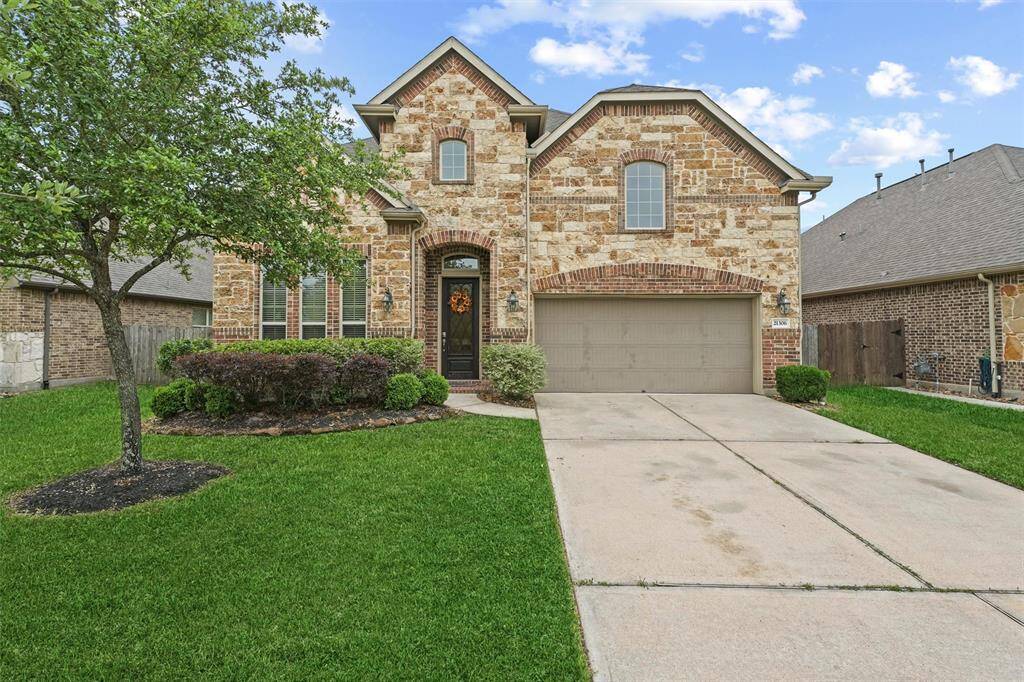 Spacious driveway offering ample parking and easy access to the two-car garage.