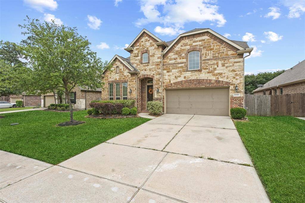 Charming two-story home with a classic brick exterior and mature landscaping.