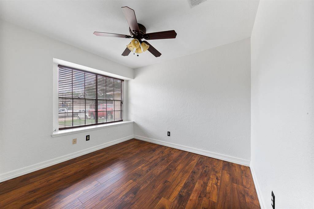 One two secondary bedrooms featuring beautiful wood floors and large windows that allow plenty of natural light. Each room offers well-sized closets, providing ample storage space and comfort.