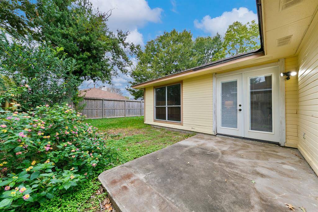 The generously sized backyard features a well-sized patio, accessible through double doors from the family room, offering a perfect space for outdoor relaxation and entertaining.