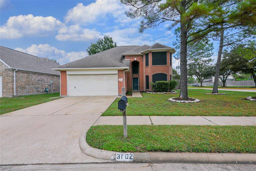 Stately home on a corner lot in the established neighborhood of Raintree Village in Katy Texas.