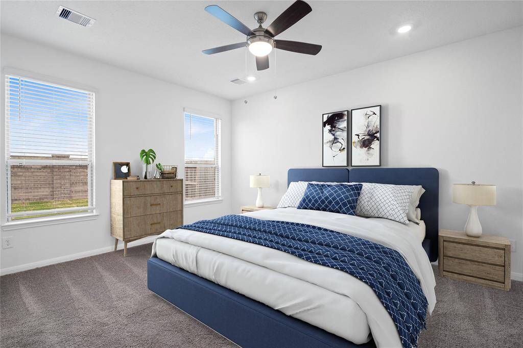 Come and unwind after a long day in this magnificent primary suite! This spacious room features plush carpet, warm paint, high ceilings with ceiling fan, and large windows with privacy blinds.