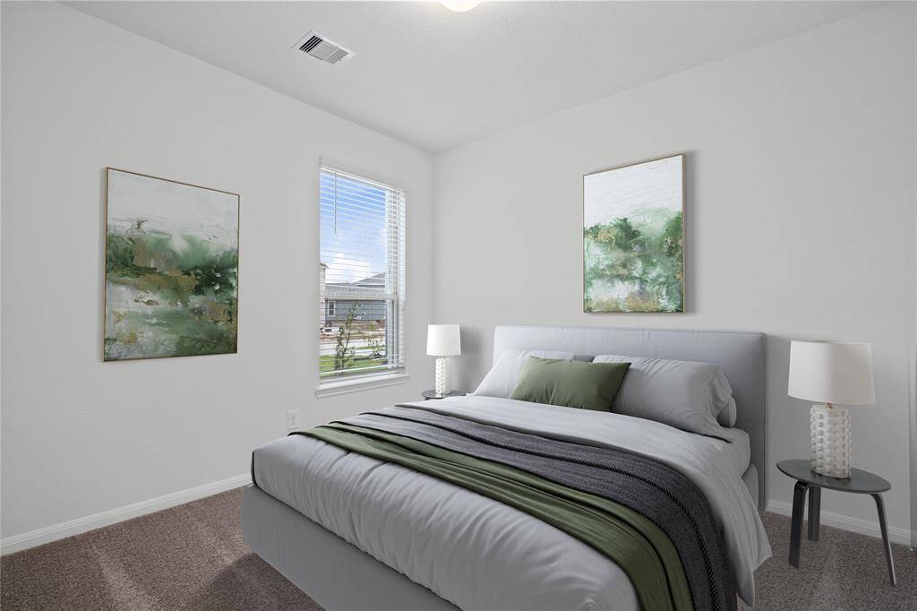 Secondary bedroom features plush carpet, custom paint, large window with privacy blinds and ample closet space.